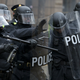 Riot police push back demonstrators during a protest in downtown Washington Friday, Jan. 20, 2017, during the inauguration of President Donald Trump. Photo via AP